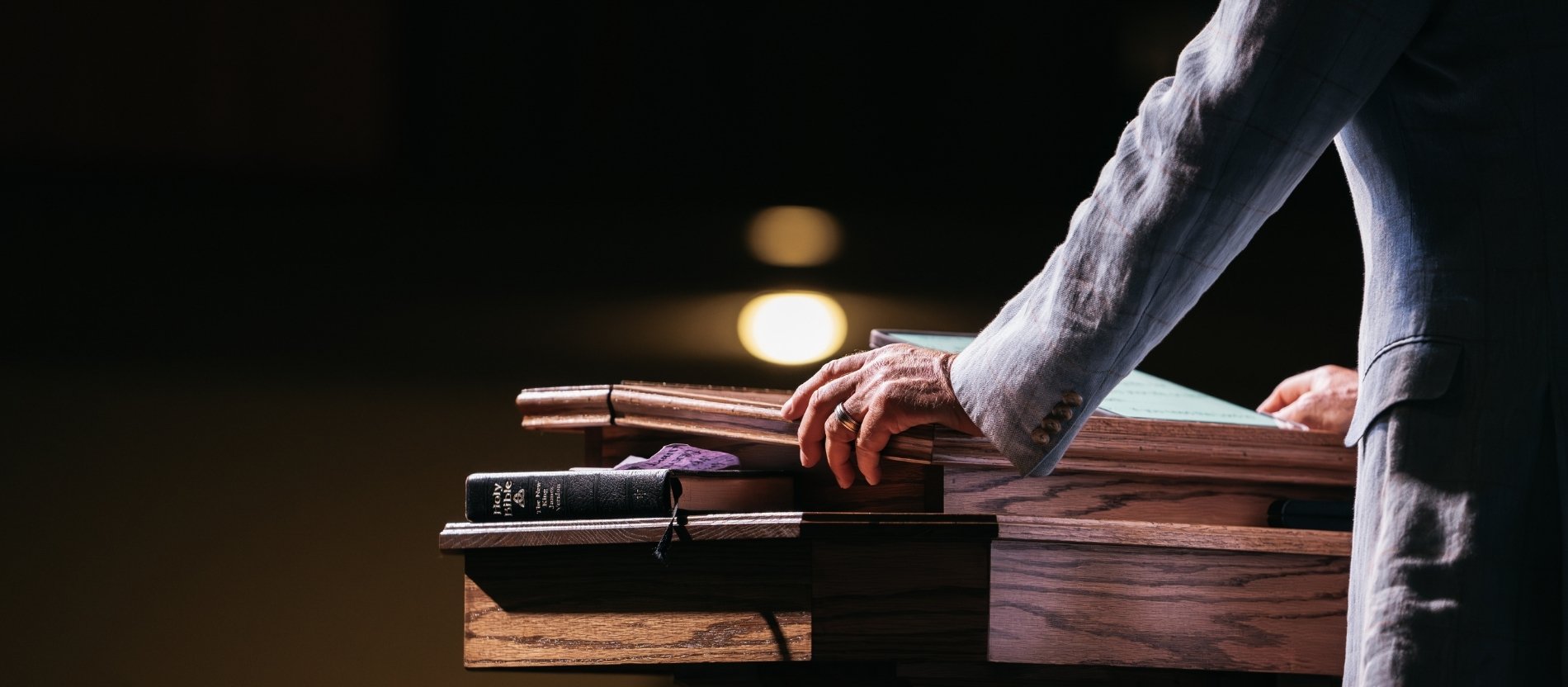 Pastor mit den Händen auf der Kanzel