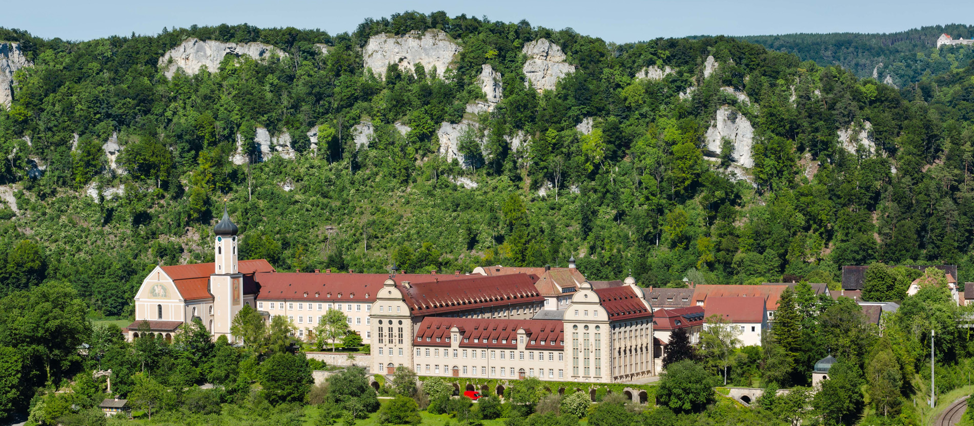 Die Erzabtei St. Martin in Beuron liegt malerisch vor Bergen.