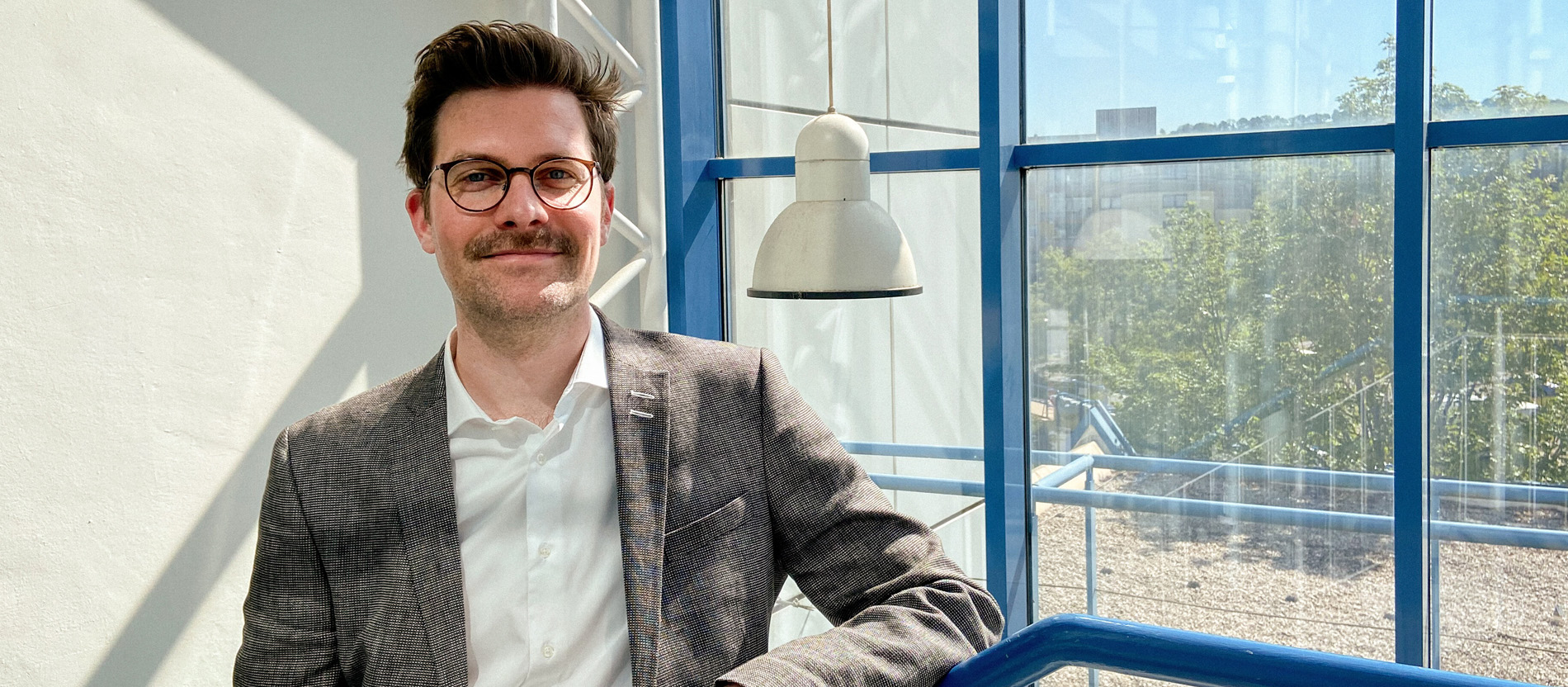 Dennis Halft in einem Treppenhaus der Uni Trier