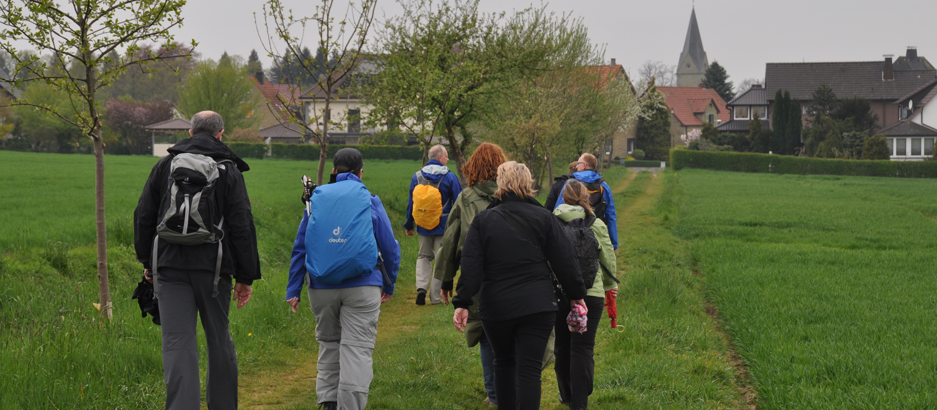Pilger laufen über einen Feldweg.